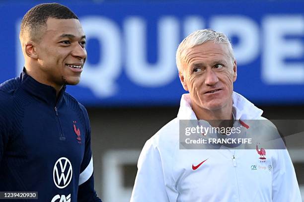 France's forward Kylian Mbappe and France's head coach Didier Deschamps during a training session in Clairefontaine-en-Yvelines near Paris on March...