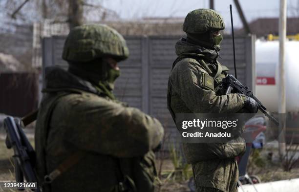 Military personnel are seen as civilians being evacuated along humanitarian corridors from the Ukrainian city of Mariupol besieged by Russian...