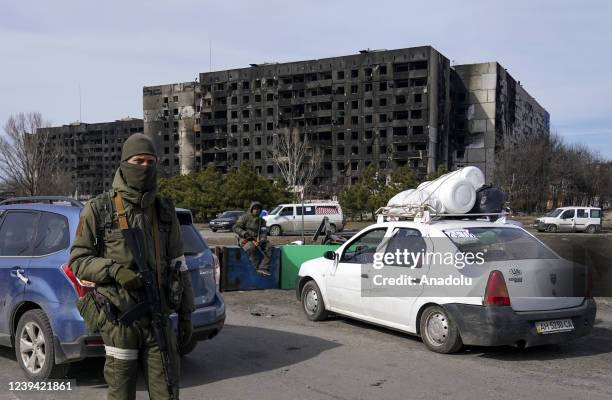 Military personnel are seen as civilians being evacuated along humanitarian corridors from the Ukrainian city of Mariupol besieged by Russian...