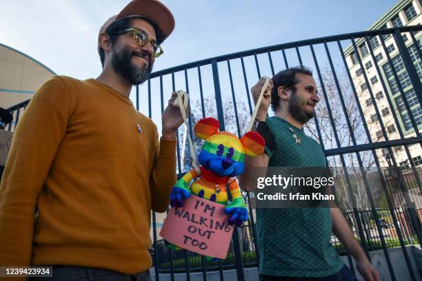 Burbank, CA LGBTQ employees Carlos Lopez Estrada , left, and Juan Pablo Reyes holding a Mickey Mouse in rainbow colors, walkout of Disney Animation...