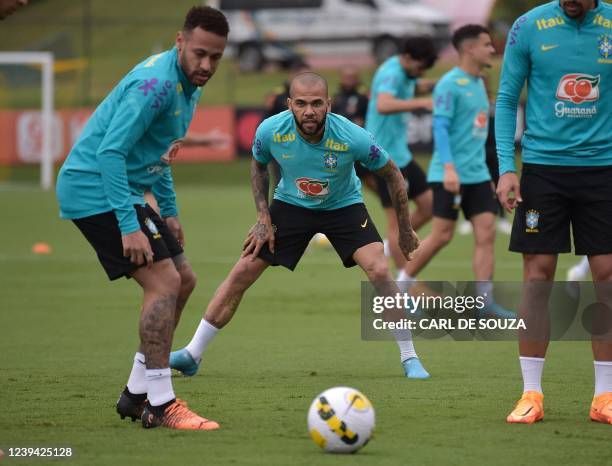 Brazil's Neymar and Dani Alves take part in a training session at the national football team's training grounds in Granja Comary, Rio de Janeiro, on...