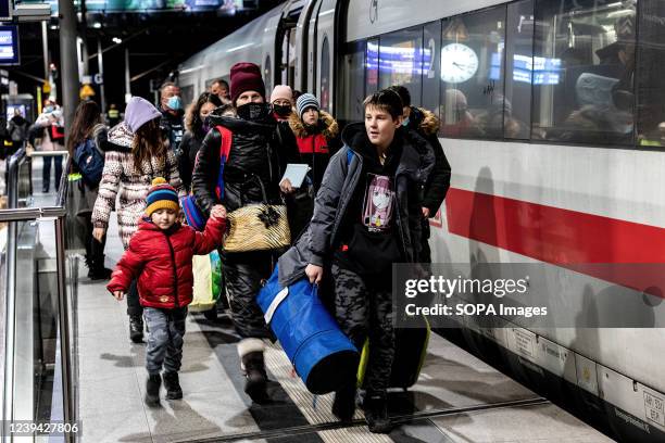 Family of Ukrainian refugees rushes to board a train to Munich on the platform at the Berlin Central Station. Since the war began, more than 3...