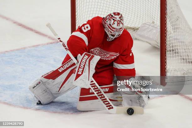 Detroit Red Wings goalie Alex Nedeljkovic blocks the puck with his stick during the first period of a regular season NHL hockey game between the...