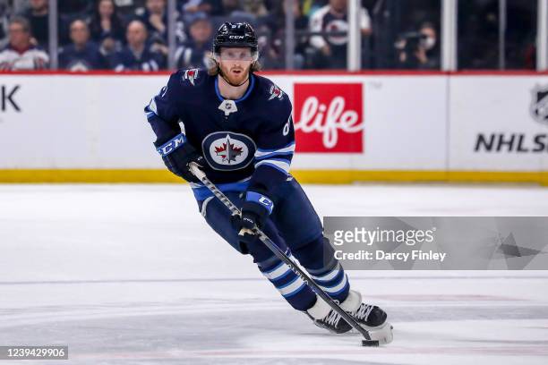 Kyle Connor of the Winnipeg Jets plays the puck down the ice during first period action against the Vegas Golden Knights at the Canada Life Centre on...