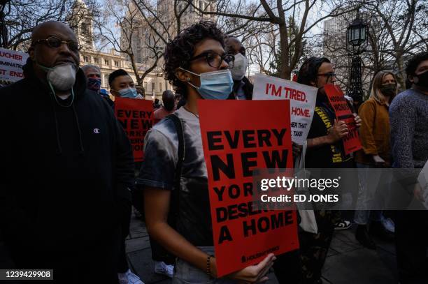 Activists, supporters, and members of the homeless community attend a protest calling for greater access to housing and better conditions at homeless...