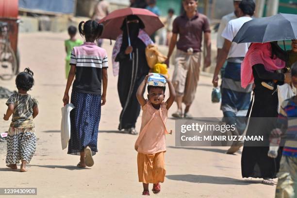 In this picture taken on March 22 a Rohingya refugee child walks to her home at Jamtoli refugee camp in Ukhia. - Hundreds of thousands of Rohingya...