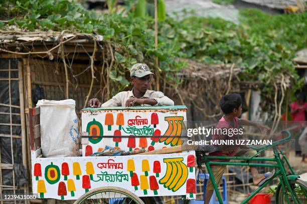 In this picture taken on March 22 a Rohingya refugee selling ice-cream waits for customers at Jamtoli refugee camp in Ukhia. - Hundreds of thousands...