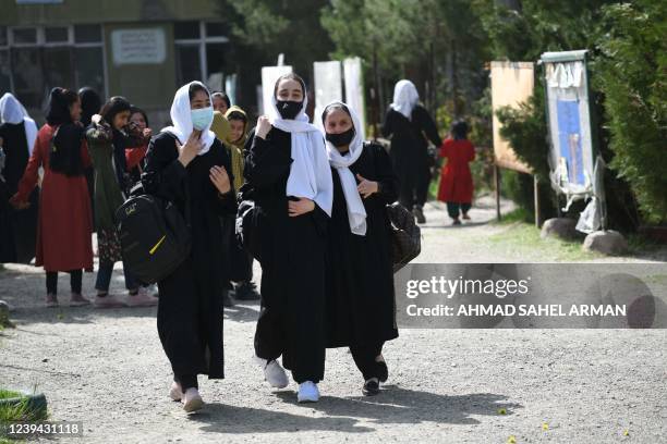 Girls leave their school following order of closure just hours after reopening in Kabul on March 23, 2022. - The Taliban ordered girls' secondary...