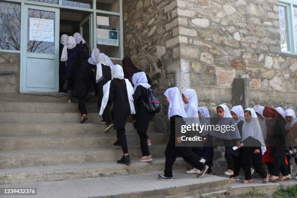 Girls arrive at their school in Panjshir on March 23, 2022. - The Taliban ordered girls' secondary schools in Afghanistan to shut on March 23 just...