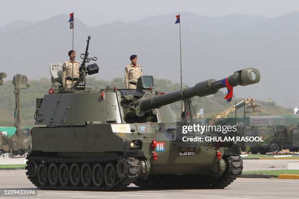 Pakistani soldiers stand atop a tank during the Pakistan Day parade in Islamabad on March 23, 2022.