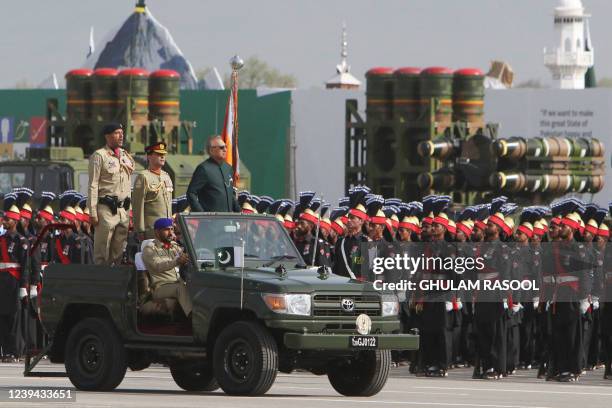 Pakistani President Arif Alvi inspects the guard of honour during the Pakistan Day parade in Islamabad on March 23, 2022.