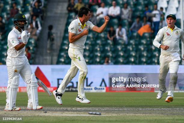 Australia's captain Pat Cummins celebrates after bowling out Pakistan's Sajid Khan during the third day of the third cricket Test match between...