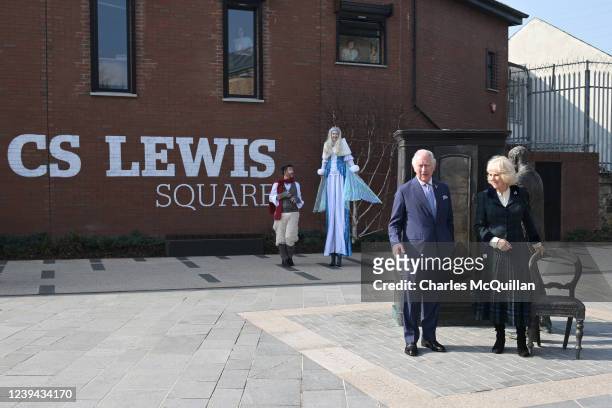 Prince Charles, Prince of Wales and Camilla, Duchess of Cornwall pose with one of the bronze sculptures commemorating the Belfast-born author, CS...