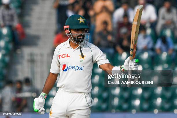 Pakistan's captain Babar Azam celebrates after scoring a half-century during the third day of the third cricket Test match between Pakistan and...