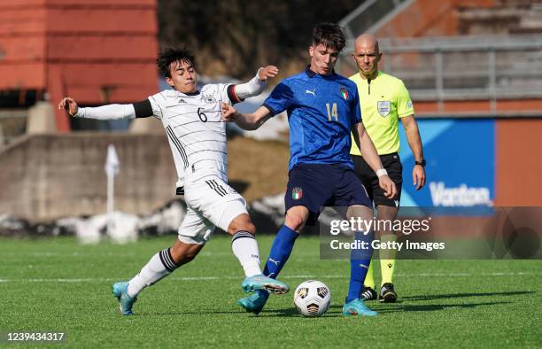 Jens Castrop of Germany reaches for the ball with Giovanni Fabbian of Italy during the UEFA Under19 European Championship Qualifier match between...