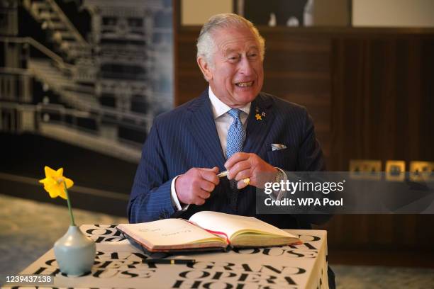 Prince Charles, Prince of Wales signs the visitors book at the re-opening of the Grand Opera house, Belfast, on the second day of a two-day visit to...