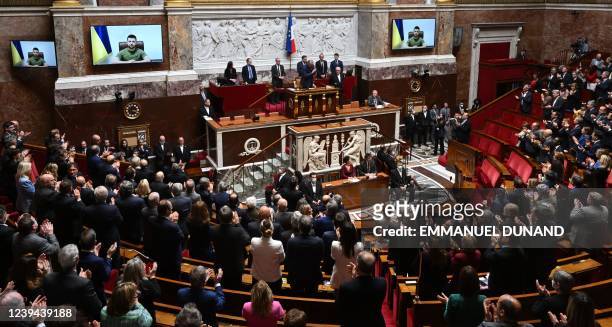 Ukrainian President Volodymyr Zelensky delivers a speech in visioconference in front of National Assembly president Richard Ferrand , French deputies...