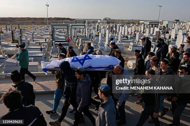 Mourners carry the body of 67-year-old Menahem Yehezkel, who was killed the previous day in a knife attack by a convicted Islamic State group...