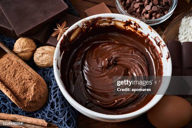 chocolate mousse making with ingredients in rustic kitchen and low key - chocolate mousse stock pictures, royalty-free photos & images