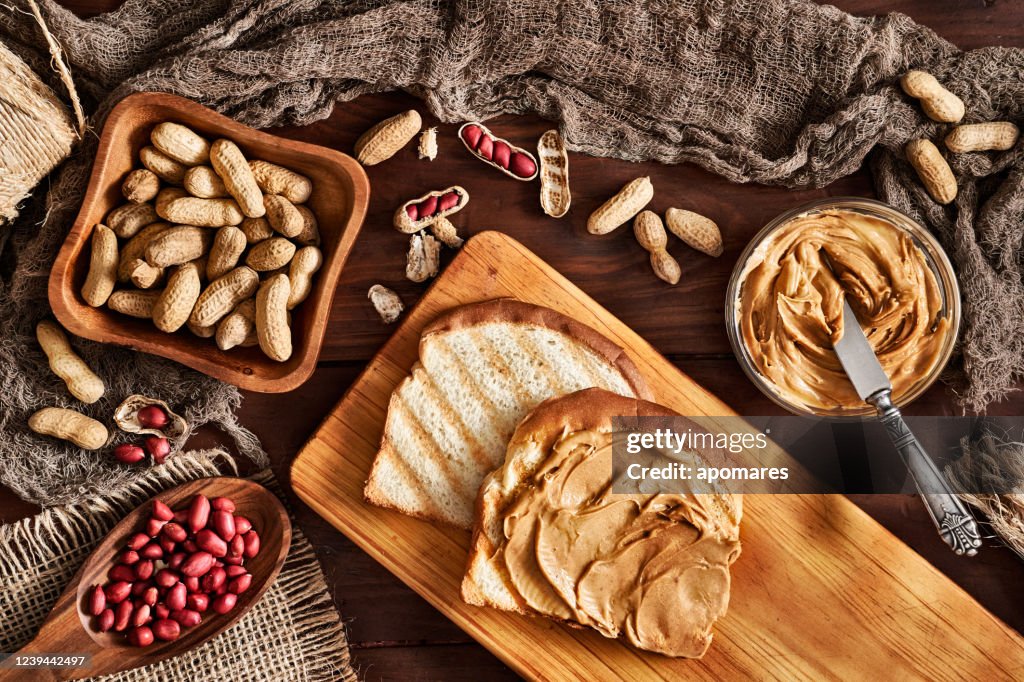 Toast with peanut butter on vintage table set in rustic kitchen