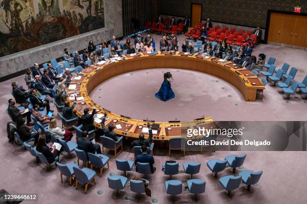 Security council members cast their votes on the resolution during the United Nations Security Council meeting at United Nations headquarters on...