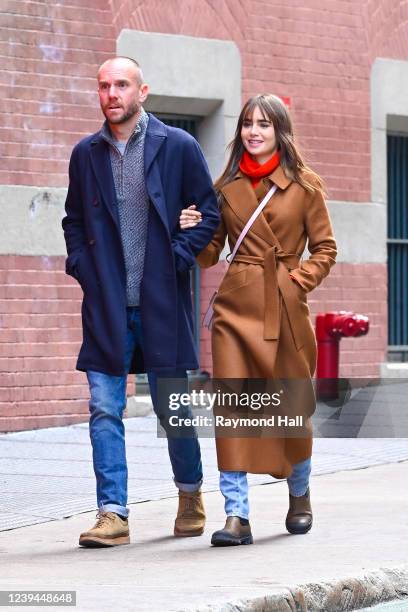 Charlie McDowell and Lily Collins are seen walking in Soho on March 23, 2022 in New York City.