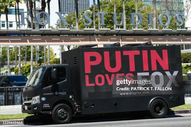 Mobile billboard truck displays signage stating "Putin Loves Fox" from Media Matters For America warning potential advertising partners about Fox...