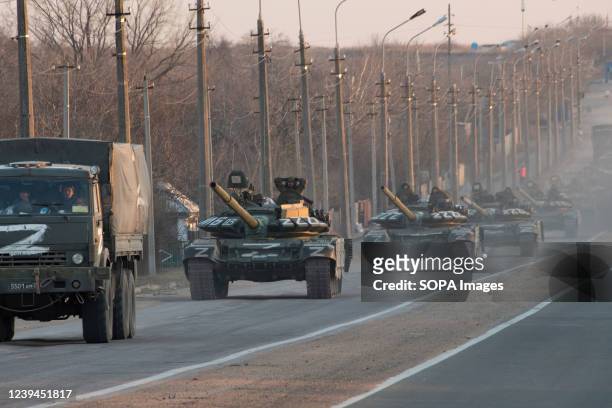 Column of tanks marked with the Z symbol stretches into the distance as they proceed northwards along the Mariupol-Donetsk highway. The battle...
