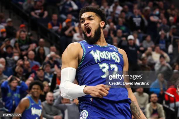 Karl-Anthony Towns of the Minnesota Timberwolves celebrates after dunking the ball against the Phoenix Suns in the second quarter of the game at...