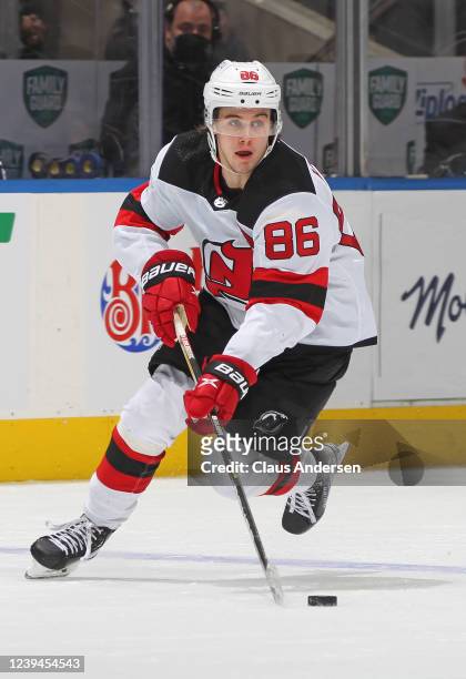 Jack Hughes of the New Jersey Devils skates the puck against the Toronto Maple Leafs at Scotiabank Arena on March 23, 2022 in Toronto, Ontario,...