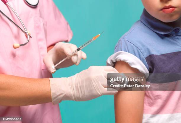 8 year old having corona virusvaccination - diphtheria stock pictures, royalty-free photos & images