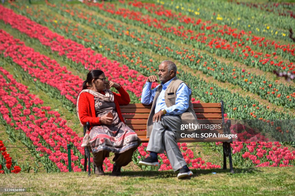 An Indian tourist couple rests on the bench at Asia's...