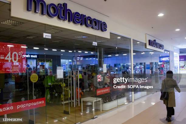 Woman walks by a Mothercare boutique in a shopping mall in Moscow. Many foreign brands announced they were suspending operations in light of the...