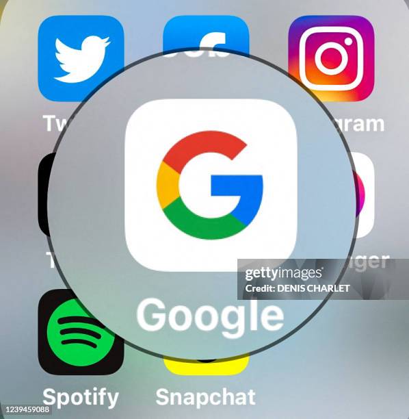 This photograph taken on March 23 shows the logo of US multinational internet technology and services company Google and other social media platforms...