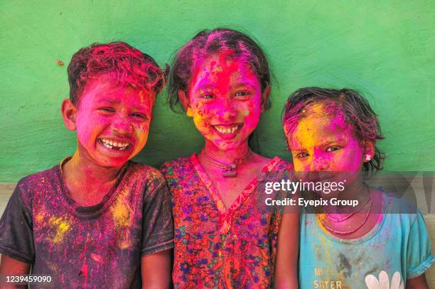 Bangladeshi children from Khan Tea garden posing for photos with their faces painted after adorning with colors like Rainbows on the celebration of...