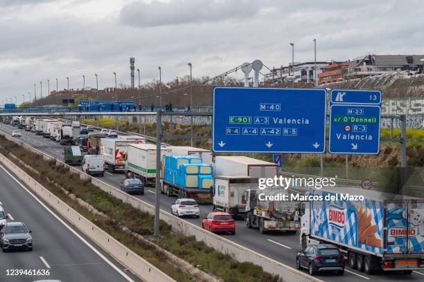 Trucks are seen making a slow march in the M-40 highway during the tenth day of a national transportation strike. Truck drivers are protesting...