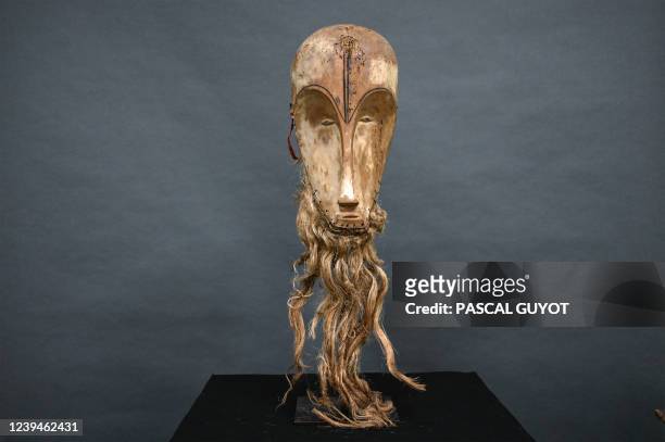 This photograph taken on March 24, 2022 shows a "Ngil" mask of the Fang people of Gabon which is estimated at 300,000/400,000 euros and which will be...
