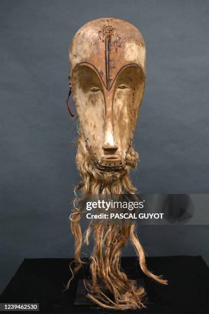 This photograph taken on March 24, 2022 shows a "Ngil" mask of the Fang people of Gabon which is estimated at 300,000/400,000 euros and which will be...