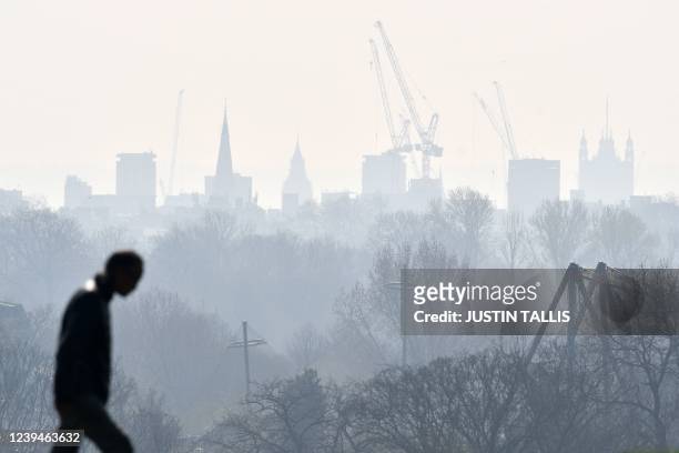 Visitor walks at Primrose Hill as a high air pollution warning was issued for London on March 24, 2022.