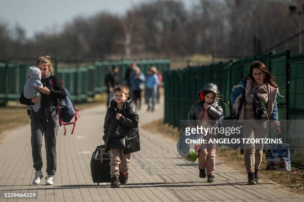 Refugees from Ukraine cross the border at the border crossing in Medyka, southeastern Poland, on March 24 following Russia's invasion of Ukraine. -...