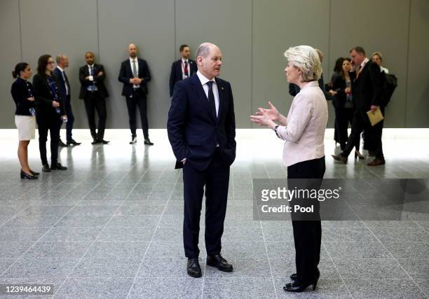 Germany's Chancellor Olaf Scholz and European Commission President Ursula von der Leyen speak before G7 leaders' family photo during a NATO summit on...