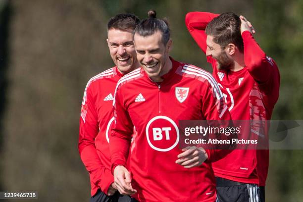 Aaron Ramsey , Gareth Bale and Ben Davies laugh during the Wales Training Session at Vale Resort on March 23, 2022 in Hensol, Wales.