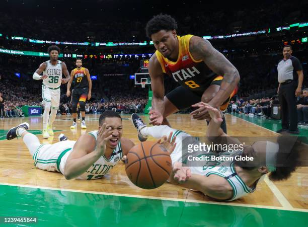 Boston Celtics forward Grant Williams reacts after losing the ball out of bounds with teammate guard Derrick White and Utah Jazz forward Rudy Gay...