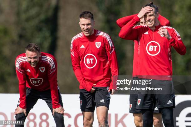 Chris Gunter, Aaron Ramsey and Gareth Bale of Wales laugh as their team mate misses a shot during the Wales Training Session at Vale Resort on March...