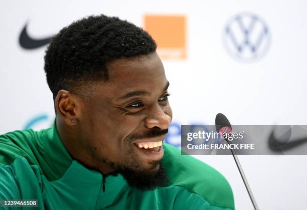 Ivory Coast's defender Serge Aurier smiles as he gives a press conference on the eve of the friendly football match between France and Ivory Coast at...
