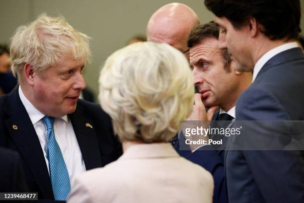 Britain's Prime Minister Boris Johnson speaks with France's President Emmanuel Macron Canada's Prime Minister Justin Trudeau and European Commission...