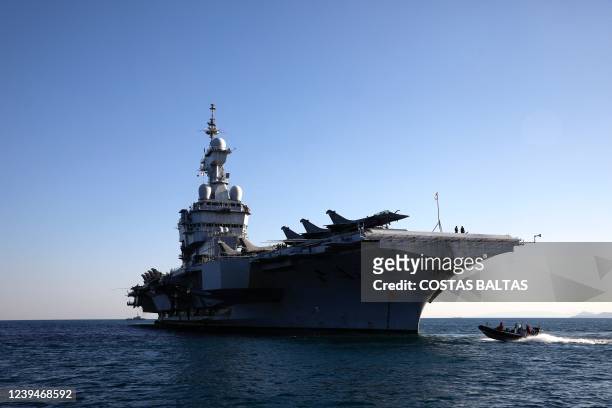 The French navy Charles de Gaulle aircraft carrier is seen off the shore of the Faliro suburb, in Athens, on March 24, 2022.