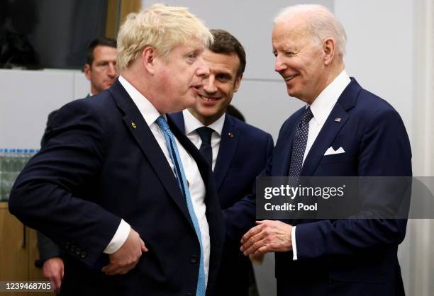 British Prime Minister Boris Johnson speaks with U.S. President Joe Biden and France's President Emmanuel Macron before a G7 leaders meeting during a...