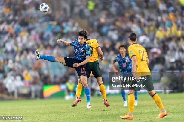 Ao Tanaka of Japan is challenged by Gianni Stensness of Australia during FIFA World Cup Qatar 2022 Qualification match between Australia and Japan at...