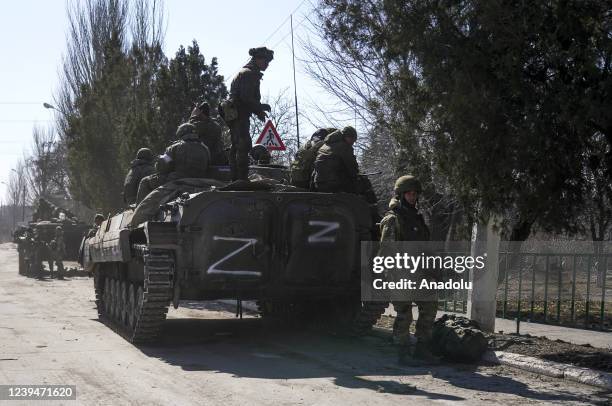 Russian military and pro-Russian separatists keep watch as civilians are being evacuated along humanitarian corridors from the Ukrainian city of...